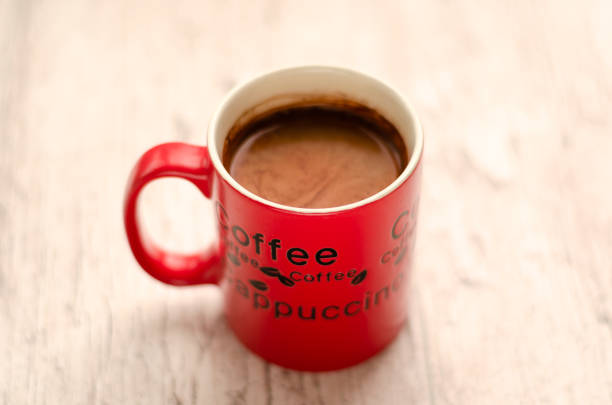 istock Red Coffee mug on wooden background. Americano 1146915014