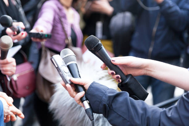 istock Journalists holding microphones at press conference 1146916586