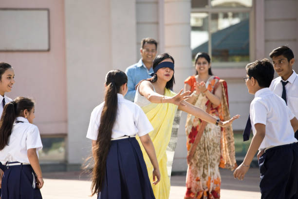 istock Teacher playing hide and seek with school children 1146918567