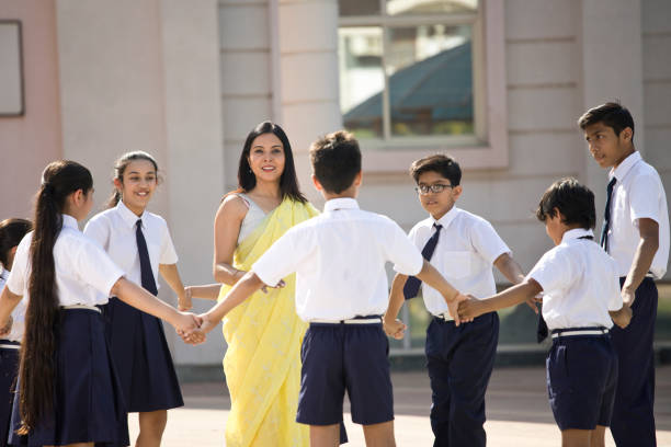 istock Teacher playing with students in campus 1146918670