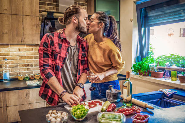 istock cheerful young couple having fun cooking together 1146918754