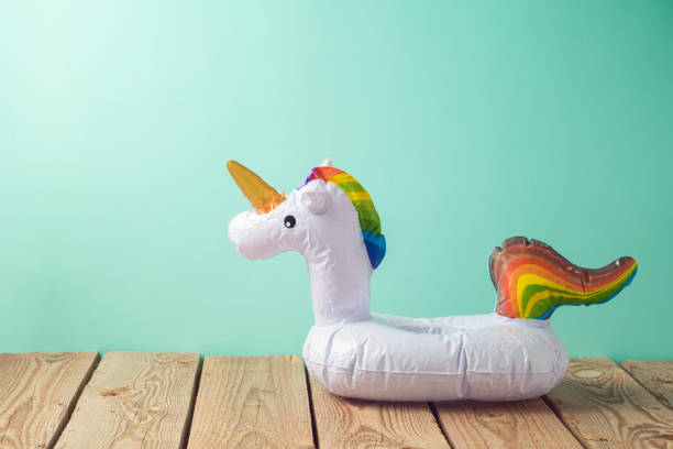 istock Summer vacation background with unicorn pool float on wooden table 1146920329