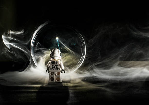 istock Toy figure looking into a light and smoke. 1146921252