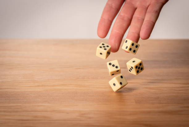 istock Hand throwing dice in front of a dark background. 1146921263
