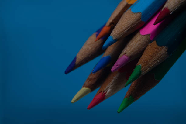 istock Beautiful multi-colored pencil in water on a blue background. 1146921407