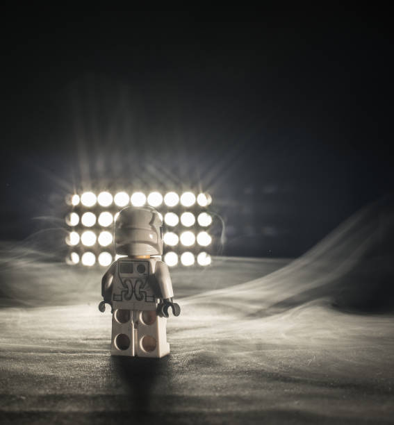 istock Toy figure looking into a light and smoke. 1146921410