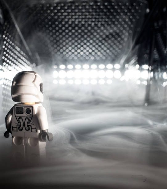 istock Toy figure looking into a light and smoke inside a grater. 1146921419