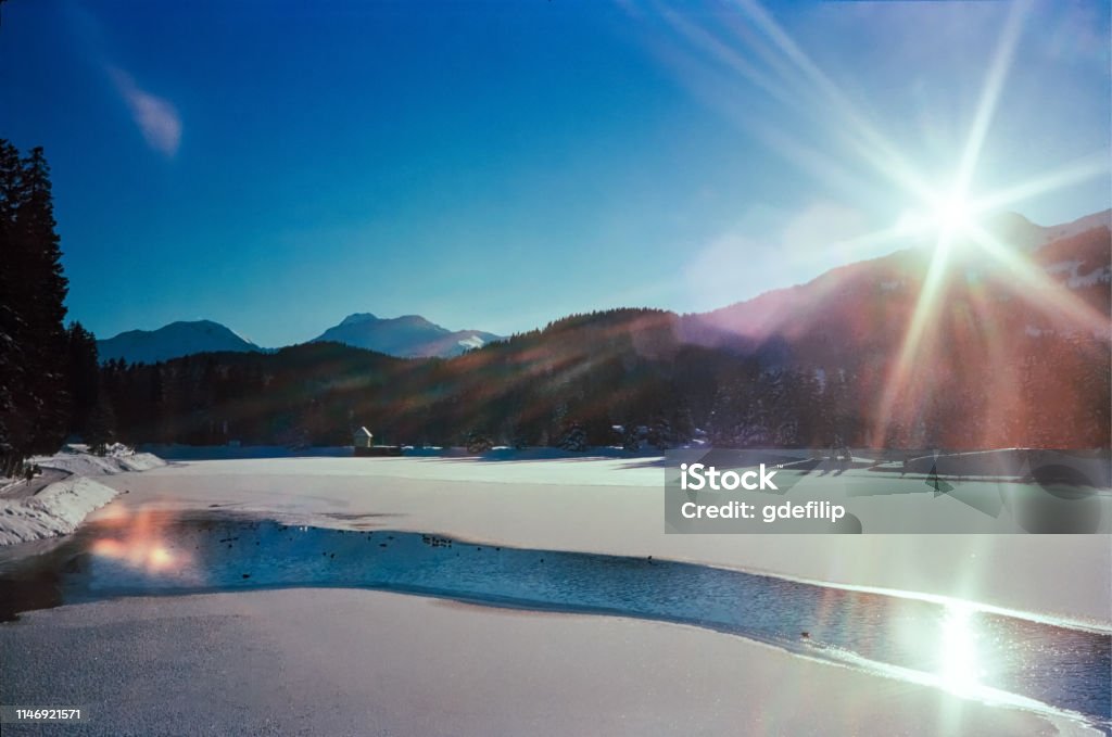 A sunny day on a frozen lake on the Swiss Alps, shot with analogue film photography Arosa Stock Photo