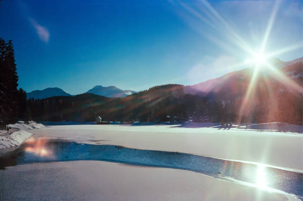 A sunny day on a frozen lake on the Swiss Alps, shot with analogue film photography A sunny day on a frozen lake on the Swiss Alps, shot with analogue film photography arosa photos stock pictures, royalty-free photos & images