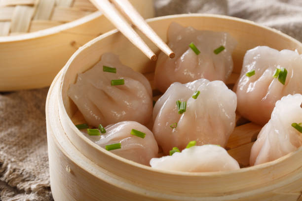 istock Chinese prawn dumplings dim sum placed in a bamboo steamer. horizontal 1146922832