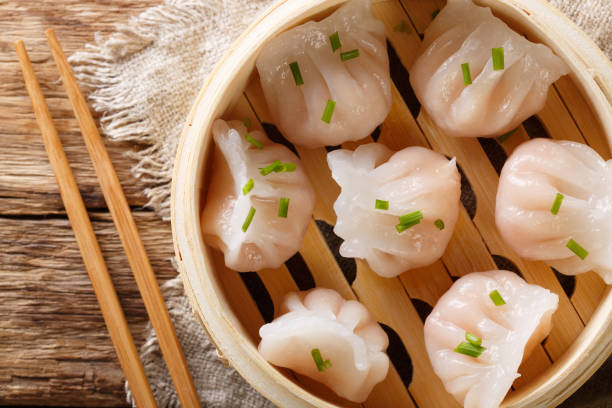 istock Chinese prawn dumplings dim sum placed in a bamboo steamer. horizontal top view 1146922861