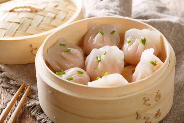 istock Dim Sum in bamboo steamer, Chinese cuisine. Closeup rustic. horizontal 1146922996