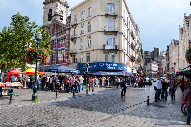 Capture of many people at and outside of seafood restaurant Mer du Nord on square Place Sainte-Catherine in Brussels at summertime. Place and restaurant are popular lunchtime meeting place.