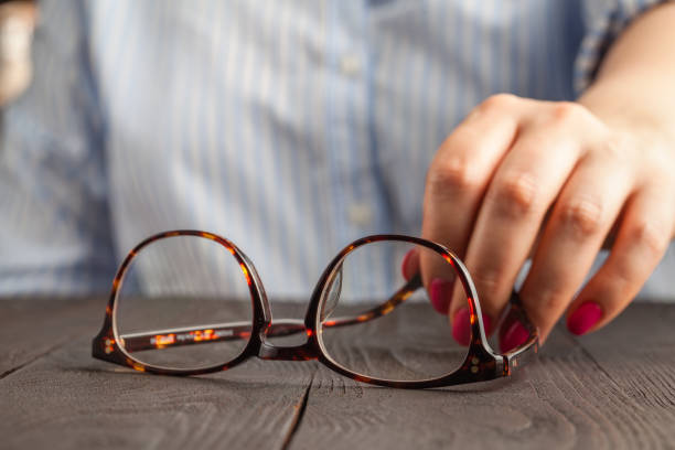 istock female hand holding a brown framed glasses 1146926815