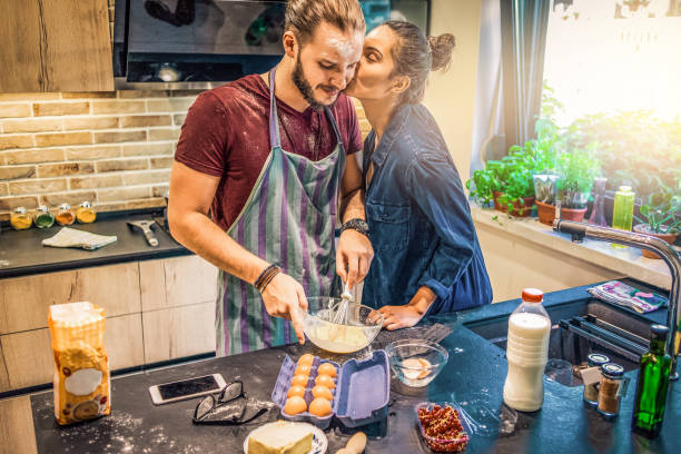 istock playful couple preparing food together 1146926818