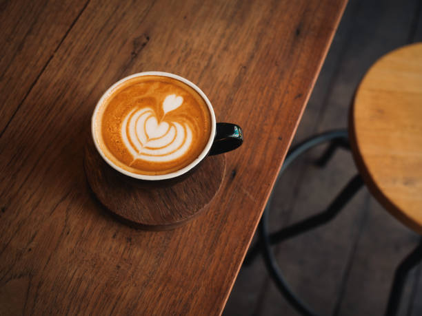 istock coffee latte on the wood desk in cafe 1146930797
