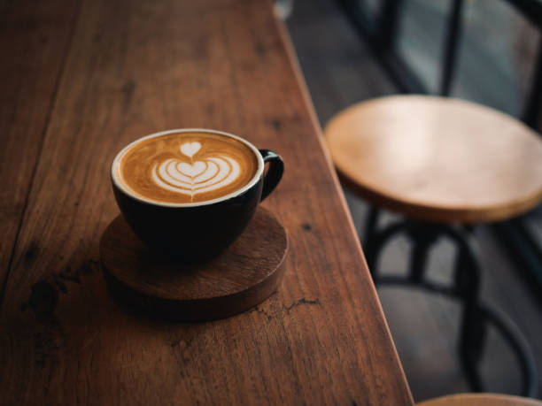 istock coffee latte on the wood desk in cafe 1146930800