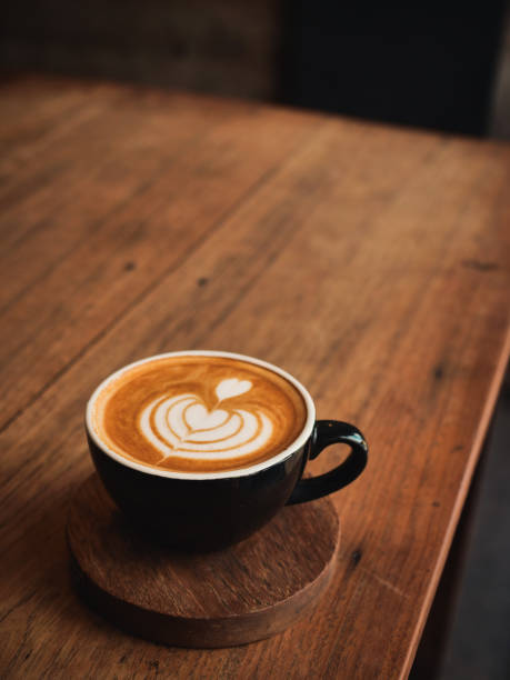 istock coffee latte on the wood desk in cafe 1146931068
