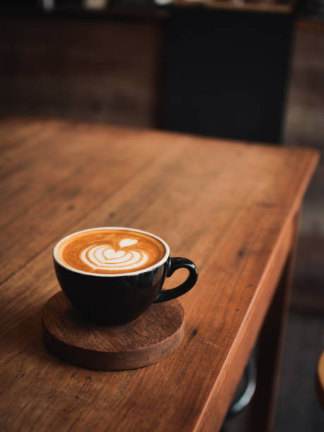 istock coffee latte on the wood desk in cafe 1146931315