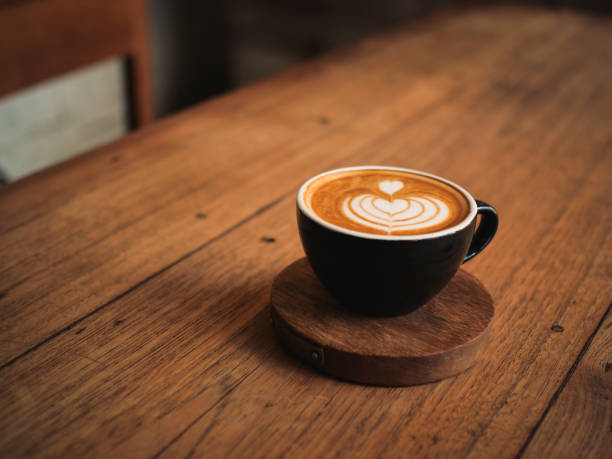 istock coffee latte on the wood desk in cafe 1146931317