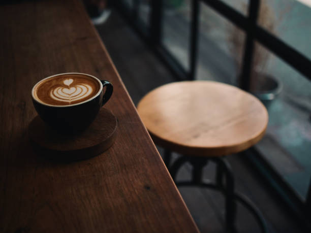 istock coffee latte on the wood desk in cafe 1146931322