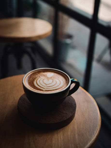 istock coffee latte on the wood desk in cafe 1146931324