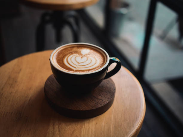 istock coffee latte on the wood desk in cafe 1146931328
