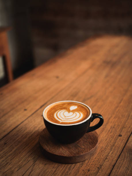 istock coffee latte on the wood desk in cafe 1146931331