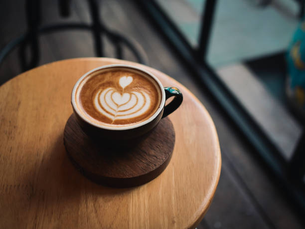 istock coffee latte on the wood desk in cafe 1146931332