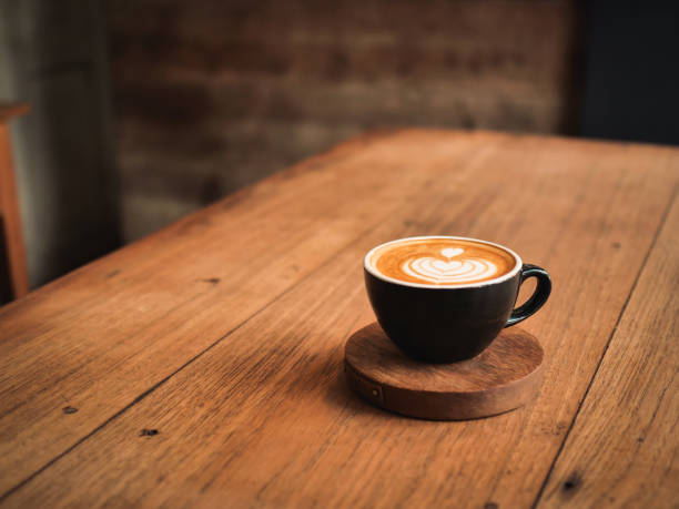 istock coffee latte on the wood desk in cafe 1146931336