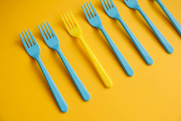 istock Close-up of blue forks on yellow background 1146931338