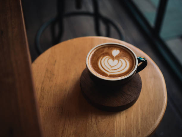 istock coffee latte on the wood desk in cafe 1146931352