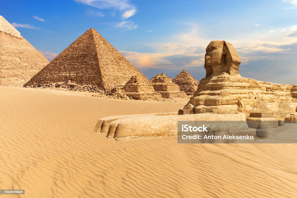 The Sphinx of Giza next to the Pyramids in the desert, Egypt The Sphinx of Giza next to the Pyramids in the desert, Egypt. Egypt Stock Photo