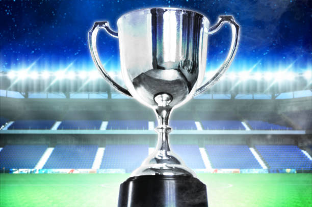 istock Celebration trophy with background football stadium which open spotlight,win concept. 1146936989