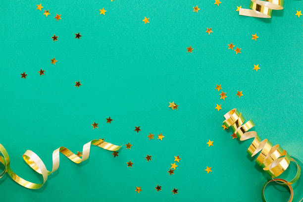 istock Golden decorations and sparkles on bright  green background 1146941909