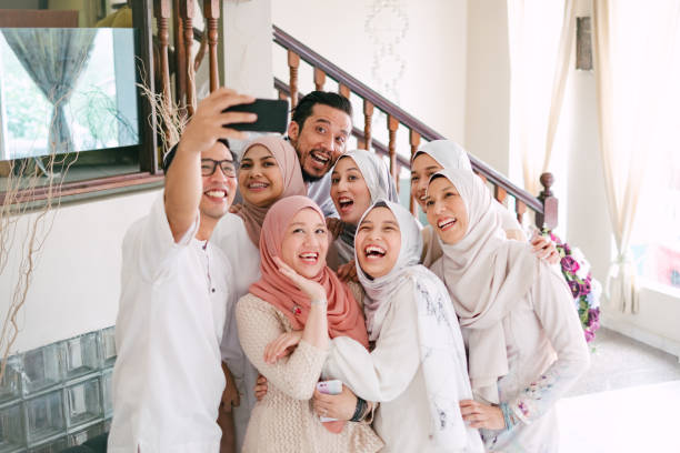 Family Taking Selfie Together Celebrating Hari Raya Aidilfitri (Eid al-Fitr) Hari Raya Aidilfitri Celebration in Malaysia eid ul fitr photos stock pictures, royalty-free photos & images