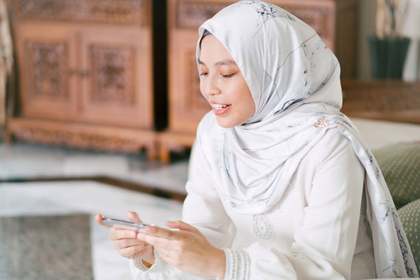 istock Young Muslim Woman Playing Mobile Phone Game 1146945186
