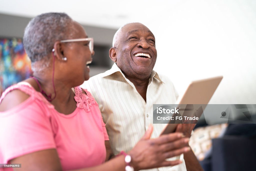 Senior couple using digital tablet Senior Adult Stock Photo