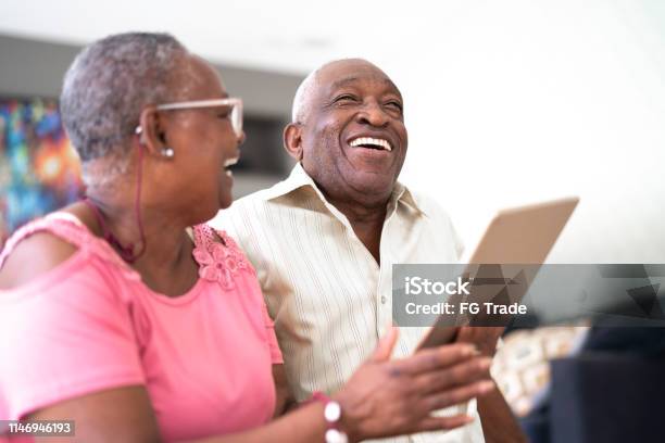 Senior Couple Using Digital Tablet Stock Photo - Download Image Now - Senior Adult, African-American Ethnicity, Digital Tablet