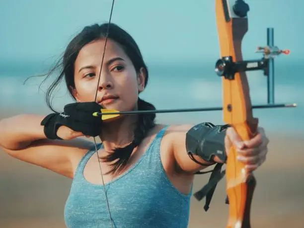 Asian Archery woman on the beach