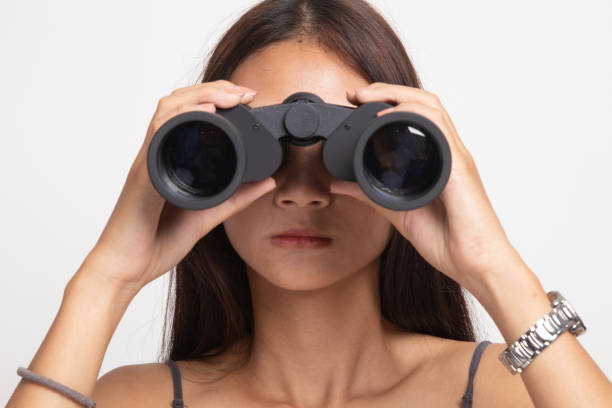 istock Young Asian woman with binoculars. 1146952834