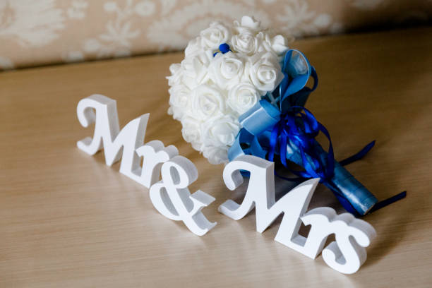 istock Mr and Mrs letters on bridal bouquet background 1146954285
