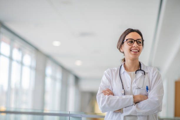 istock Smiling female physician standing in hospital corridor 1146955829