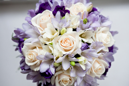 Wedding bouquet of roses and freesias in white and gray flowers