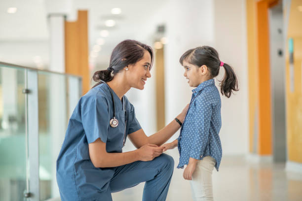 istock Kind medical professional meets with child patient 1146955870