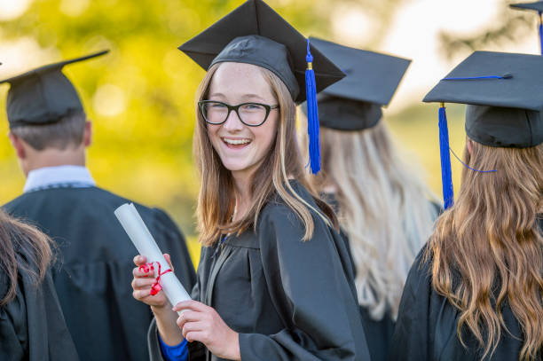 istock Graduating woman with diploma 1146959846