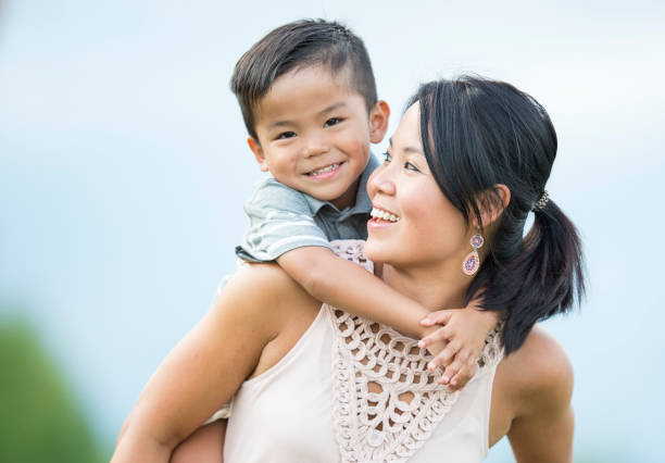 istock Mother with Young Son on her Back Playing Outside 1146961107
