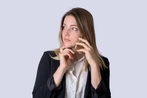 istock Business woman talking on the mobile phone on studio. 1146961655