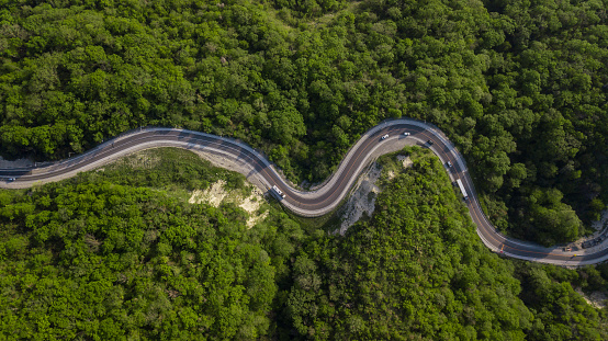 Curvy switchback highway with hairpin turns snaking through the woods