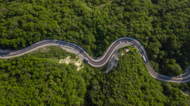 aerial top down view: of cars driving on zig zag winding mountain road - road winding road highway mountain imagens e fotografias de stock